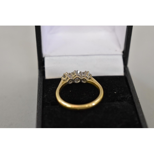 64 - A brilliant cut diamond three stone gold ring, hallmarked 750, 0.75ct approximately, 4.2g total weig... 