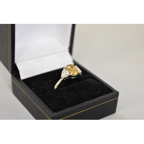 66 - A yellow and white diamond three stone platinum ring, hallmarked .950, central diamond 1.5ct ap... 