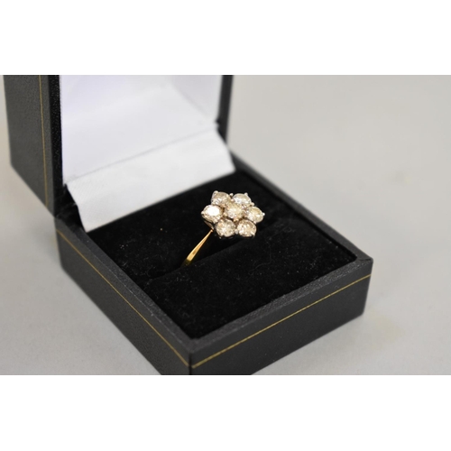 67 - A diamond 'daisy' gold ring, stamped 18ct, 4.2g total weight.