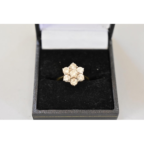 67 - A diamond 'daisy' gold ring, stamped 18ct, 4.2g total weight.