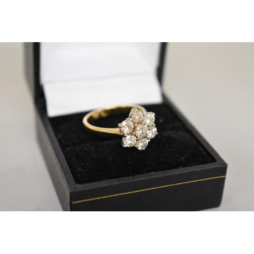 67 - A diamond 'daisy' gold ring, stamped 18ct, 4.2g total weight.