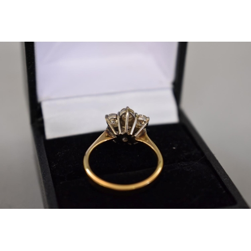 67 - A diamond 'daisy' gold ring, stamped 18ct, 4.2g total weight.