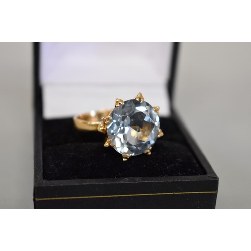 68 - A large blue topaz gold cocktail ring, stamped 750, 7.1g total weight.