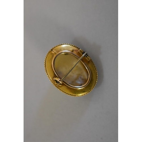 405 - A Victorian baroque mother of pearl oval gold brooch, 3.3 x 2.5cm, 13.2g total weight, (tested as 15... 