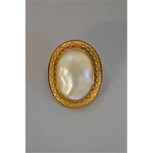 405 - A Victorian baroque mother of pearl oval gold brooch, 3.3 x 2.5cm, 13.2g total weight, (tested as 15... 