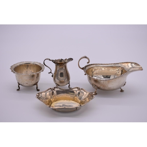 367 - A silver sauce boat, by Horace Woodward & Co Ltd, London 1916; together with a silver creamer an... 