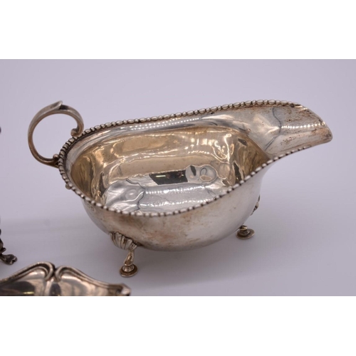 367 - A silver sauce boat, by Horace Woodward & Co Ltd, London 1916; together with a silver creamer an... 