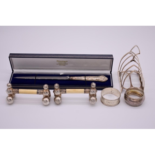 376 - A small quantity of silver and other items, to include a silver toast rack and a cased silver handle... 