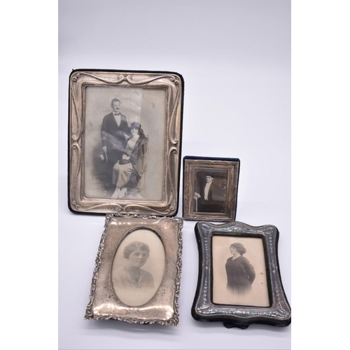 381 - An Edwardian silver photograph frame, Birmingham 1906, aperture 19.5 x 14cm; together with three sim... 