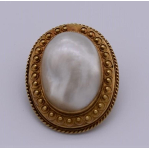 405 - A Victorian baroque mother of pearl oval gold brooch, 3.3 x 2.5cm, 13.2g total weight, (tested as 15... 