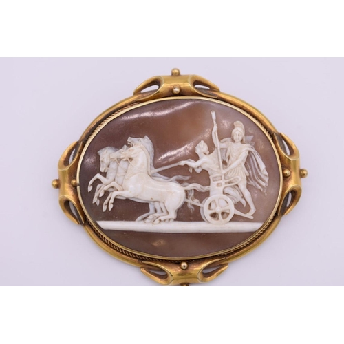 406 - A Victorian carved shell cameo yellow metal brooch, depicting Roman charioteers, 7cm wide.... 