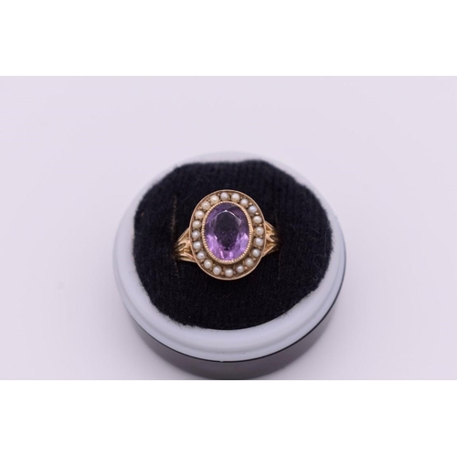 414 - An oval amethyst and pearl unmarked yellow metal ring, 3.4g total weight.