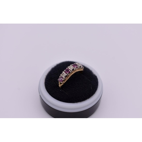 417 - A ruby and diamond gold ring, hallmarked 375, 2g total weight.