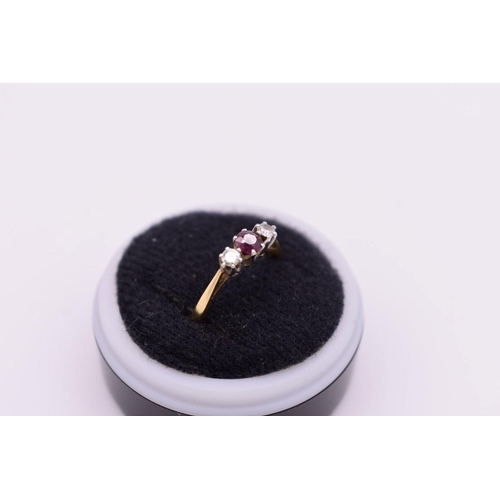 418 - A three stone ruby and diamond gold ring, stamped 18ct and plat, 2.8g.