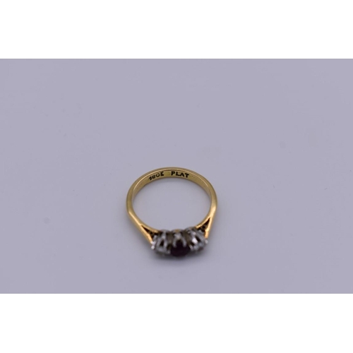 418 - A three stone ruby and diamond gold ring, stamped 18ct and plat, 2.8g.