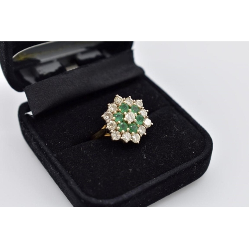 421 - An emerald and diamond cluster gold ring, hallmarked 18ct, 6.5g total weight.