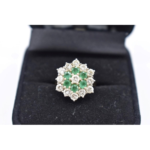 421 - An emerald and diamond cluster gold ring, hallmarked 18ct, 6.5g total weight.