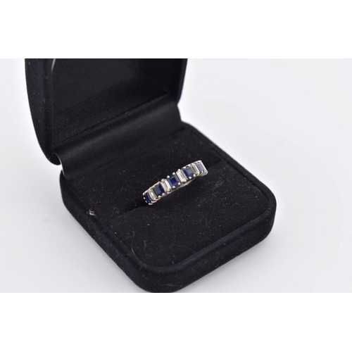 423 - A square cut sapphire and baguette diamond half eternity white gold ring, hallmarked 18ct/750, ... 