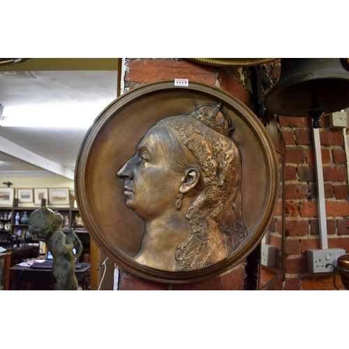 1117 - A large gilt bronze portrait relief plaque of Queen Victoria, 46cm diameter.