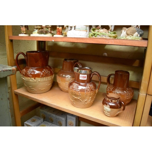 1159 - Five stoneware harvest jugs; to include one with silver rim. 