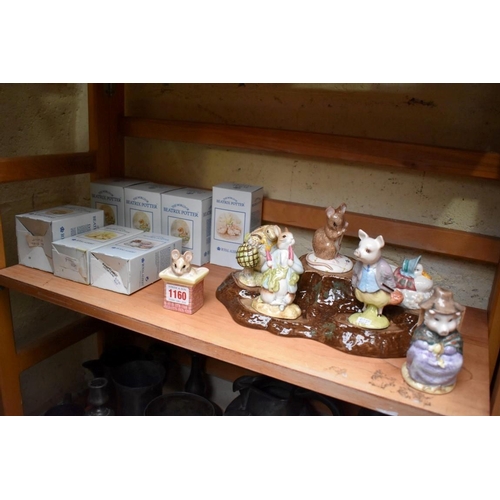 1160 - A collection of seven Royal Albert Beatrix Potter figures, each boxed; together with display st... 