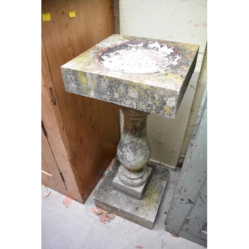 1165 - An old weathered composition stone pedestal bird bath, 76cm high.