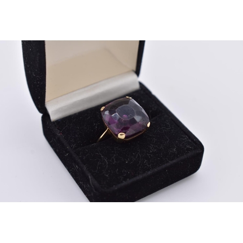 105 - A cushion cut amethyst gold cocktail ring, stamped 9ct, 5.5g total weight.