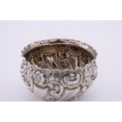 36 - A repousse silver sugar bowl, London marks indistinct, 5.5cm high, 74.5g.