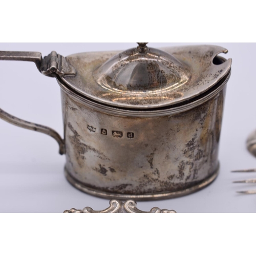 47 - A small group of silver items, to include: an Edwardian silver mustard; a Georgian caddy spoon; and ... 