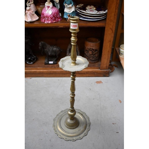 1209 - A large antique Continental brass candlestick, 70cm high.  