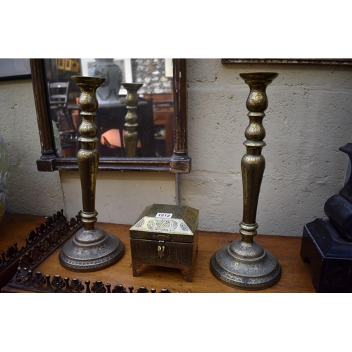 1212 - A pair of Islamic brass candlesticks, 39.5cm high; together with a similar casket.... 