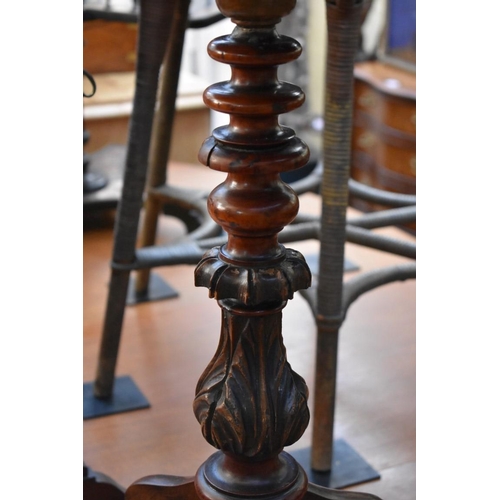 1236 - An antique mahogany circular tripod table, 61cm diameter. 