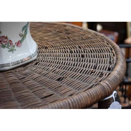 1238 - An old wicker circular table, on six legs, 57.5cm diameter. 