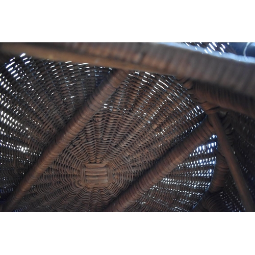 1238 - An old wicker circular table, on six legs, 57.5cm diameter. 