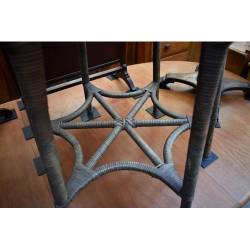 1238 - An old wicker circular table, on six legs, 57.5cm diameter. 