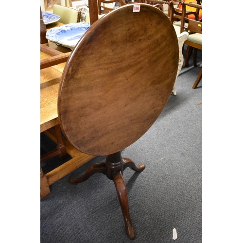 1864 - A George III mahogany revolving circular tilt-top tripod table, with one piece top, 64cm diameter.... 