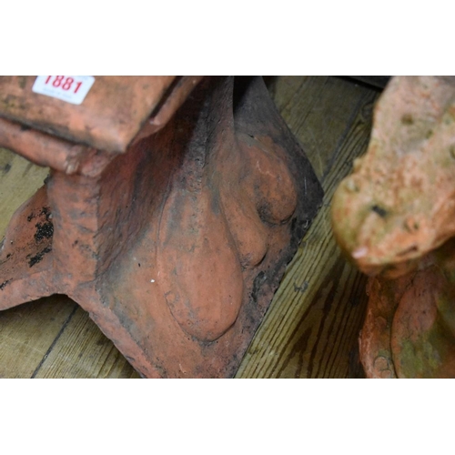 1881 - A red composition stone Bull roof ridge tile, 37.5cm wide.