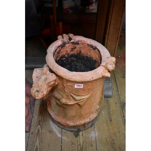 1882 - A red composition stone chimney pot, applied with a dragon, 40cm high.