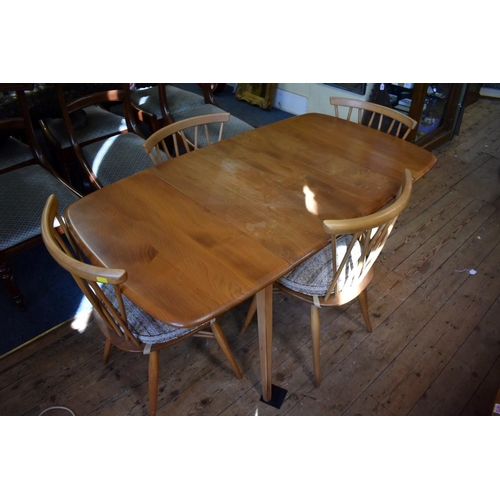 1872 - A vintage blonde Ercol drop leaf table and four chairs, 137cm wide.