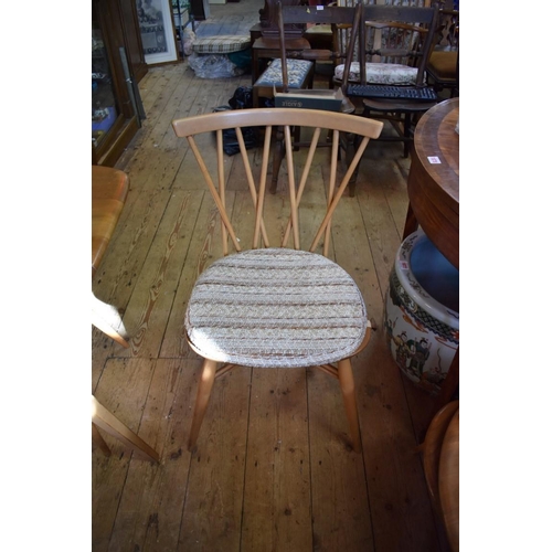 1872 - A vintage blonde Ercol drop leaf table and four chairs, 137cm wide.