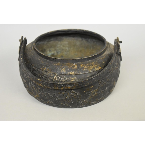 623 - A Chinese bronze swing handled vessel and pierced cover, possibly a hand warmer, xuande four charact... 