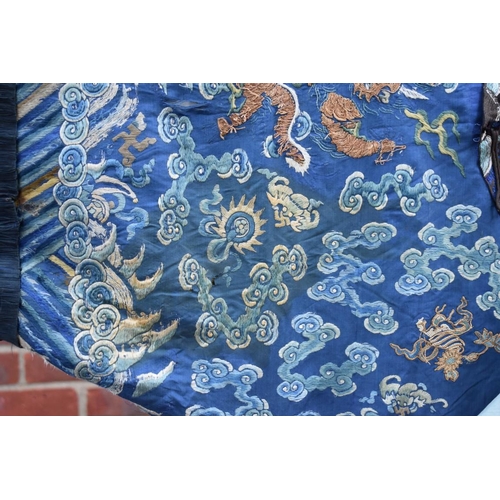 658 - A Chinese silk embroidered nine-dragon robe, 19th century, decorated with five-clawed dragons.... 