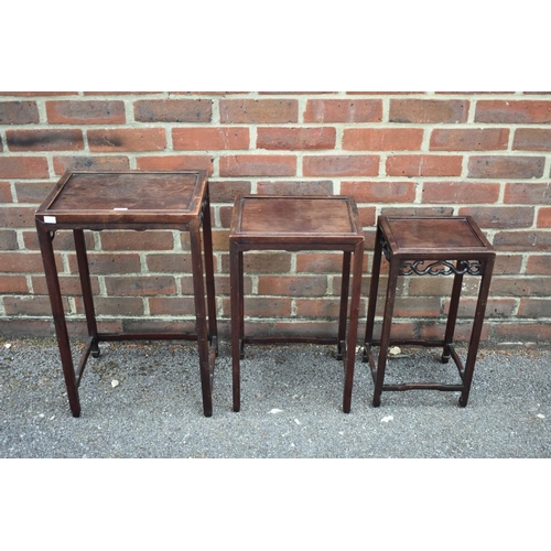 673 - A nest of three Chinese hardwood tables, 38.5cm wide.