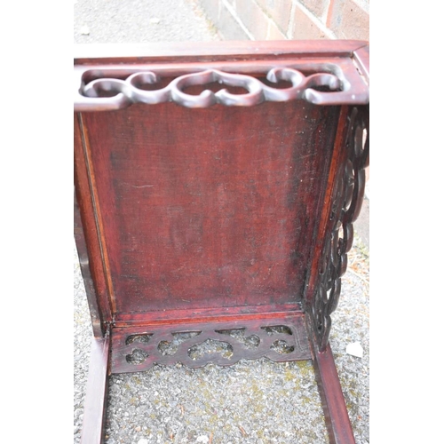 673 - A nest of three Chinese hardwood tables, 38.5cm wide.