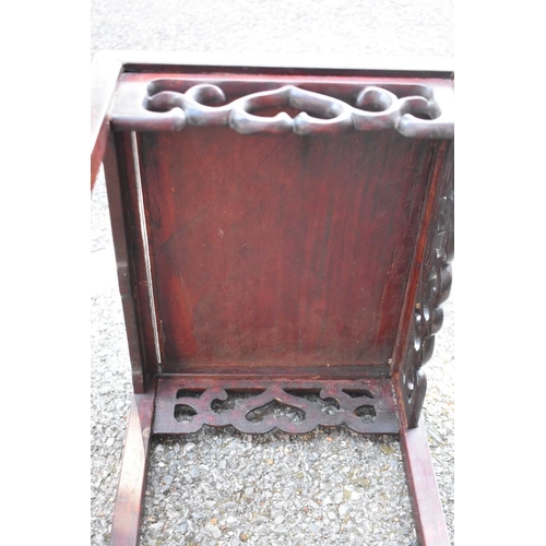 673 - A nest of three Chinese hardwood tables, 38.5cm wide.