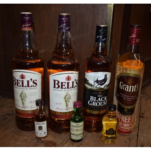 97 - Four bottles of blended whisky, comprising: two 1 litre bottles of Bell's, (seal on one broken); a 7... 