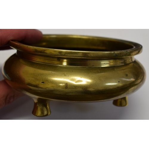 625 - A Chinese polished bronze tripod censer, xuande six character mark to base, 11.5cm diameter, 367g.... 