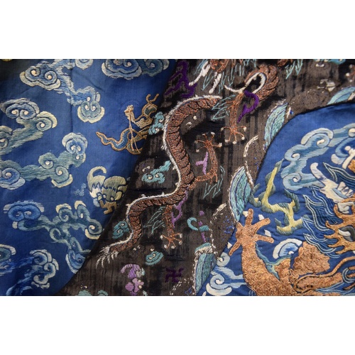 658 - A Chinese silk embroidered nine-dragon robe, 19th century, decorated with five-clawed dragons.... 