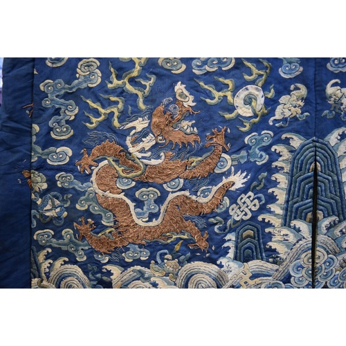 658 - A Chinese silk embroidered nine-dragon robe, 19th century, decorated with five-clawed dragons.... 