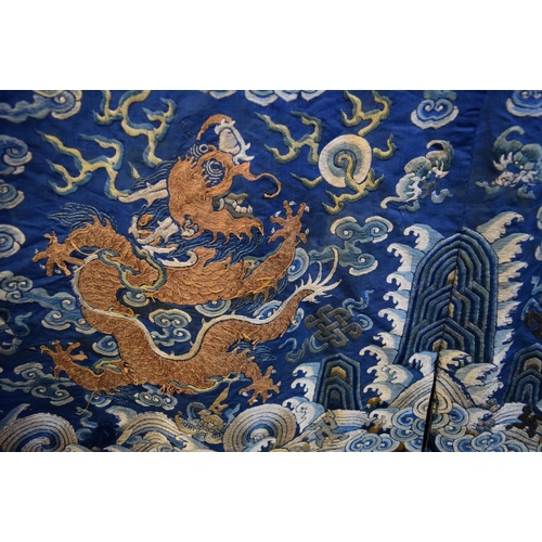 658 - A Chinese silk embroidered nine-dragon robe, 19th century, decorated with five-clawed dragons.... 